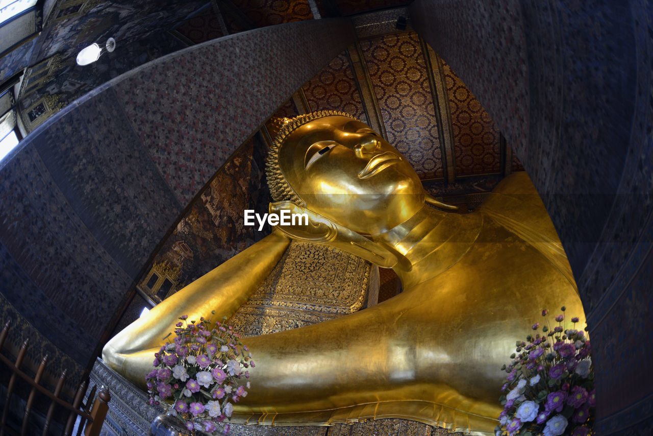 Close-up of golden buddha statue in temple