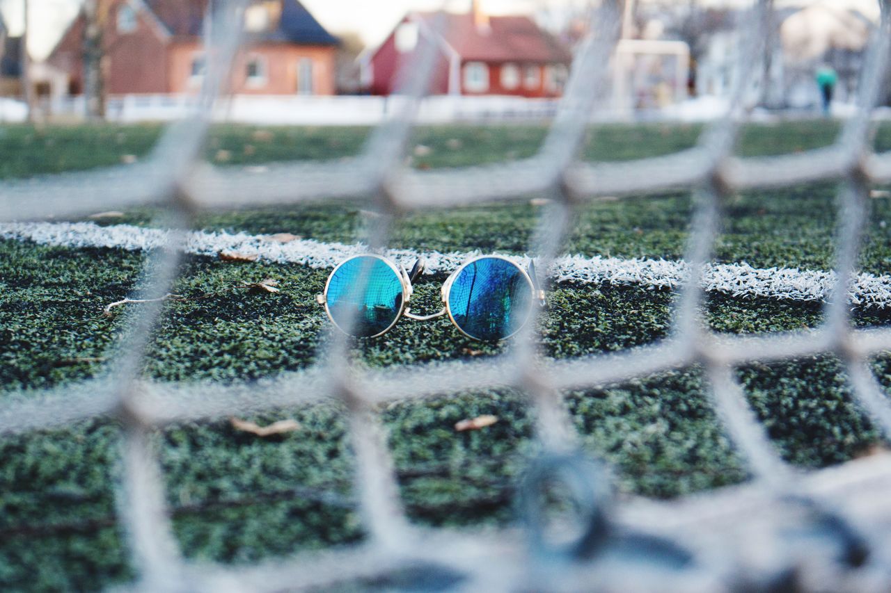 CLOSE-UP OF SOCCER BALL ON FIELD IN BACKGROUND