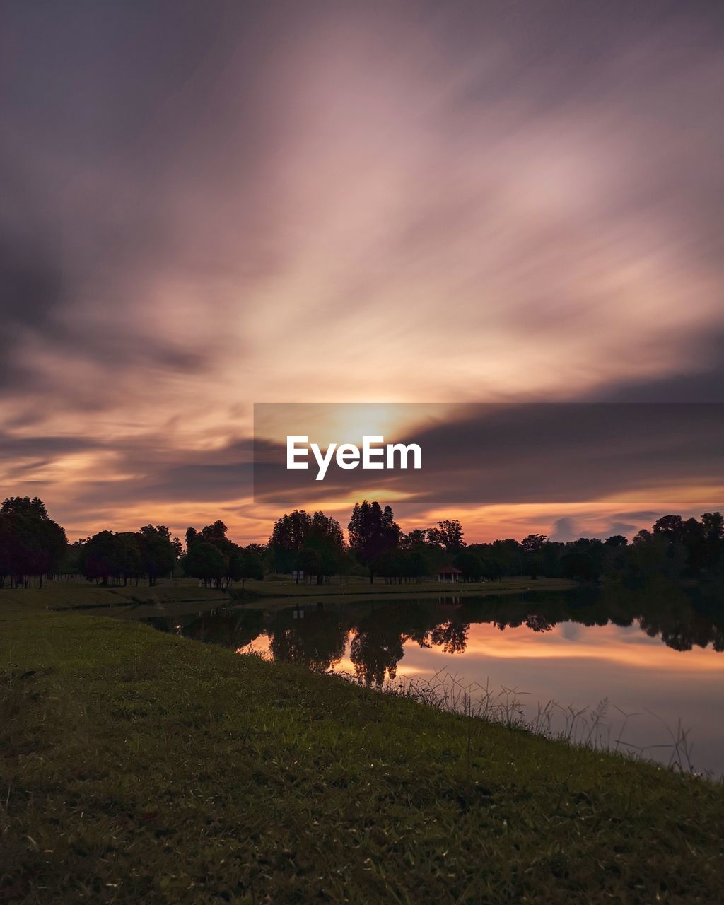 Scenic view of lake against sky during sunset