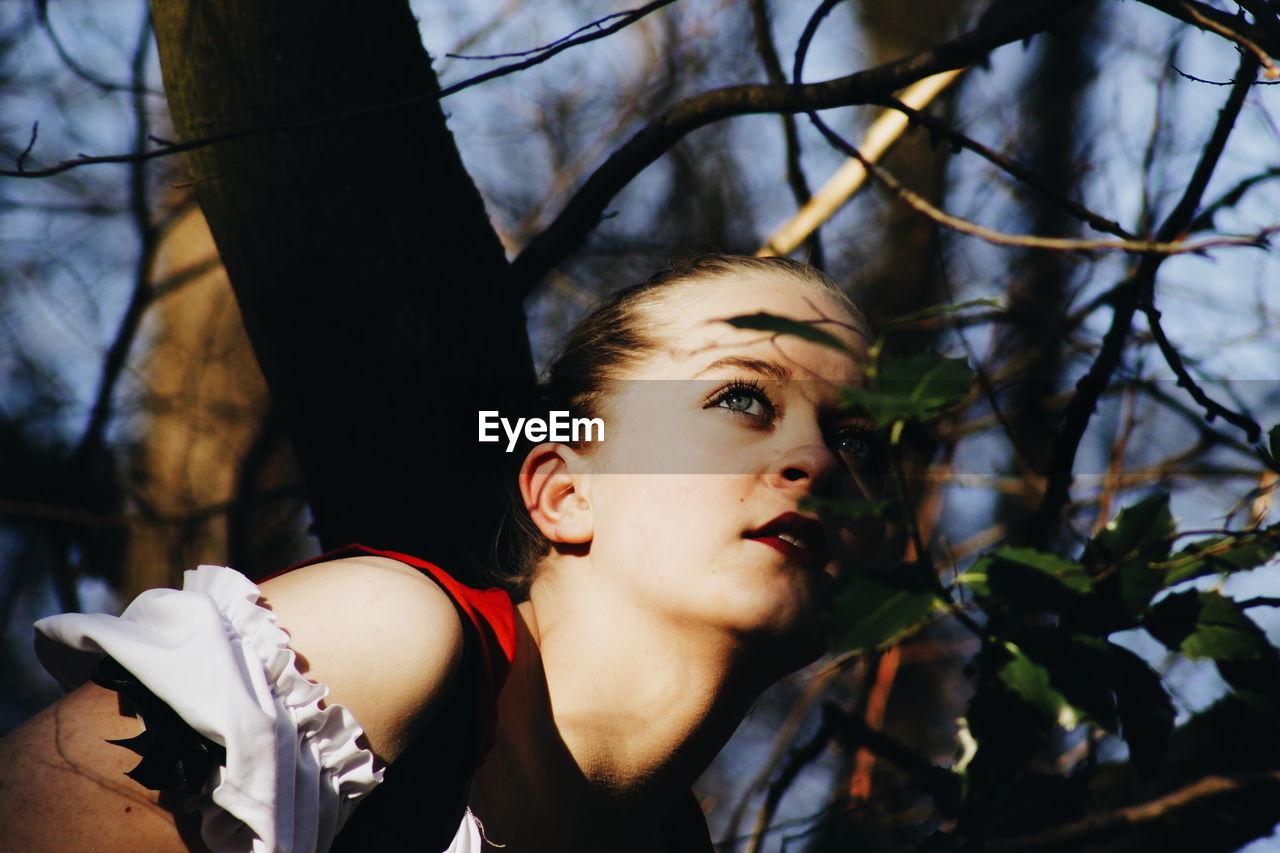 Close-up of thoughtful woman in forest