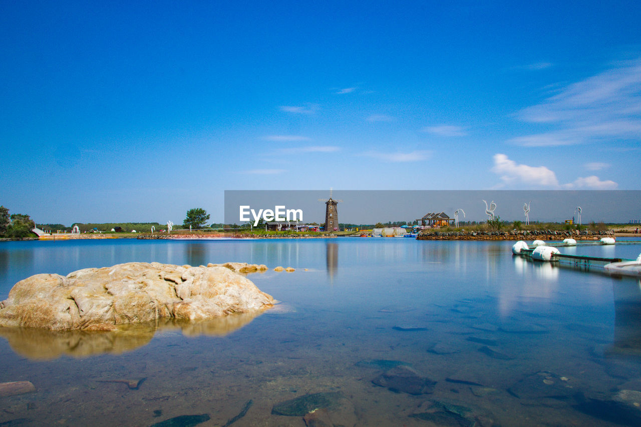 Scenic view of sea against blue sky