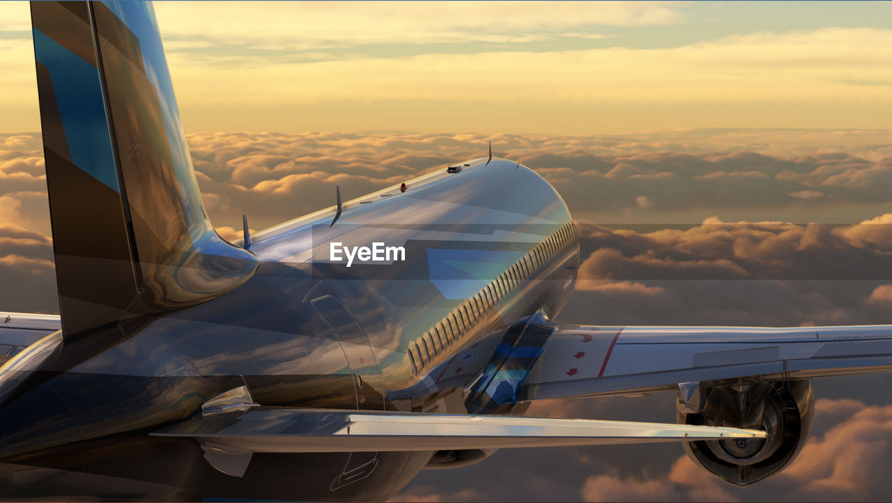  flying above the clouds in warm light. sunset or sunrise background. cropped image of airplane wing