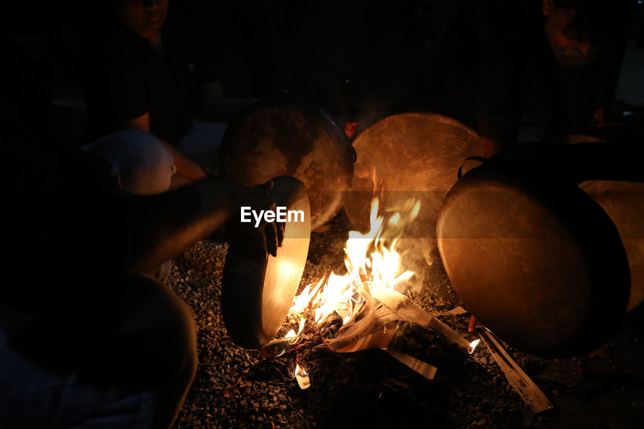 heat, burning, fire, darkness, campfire, flame, men, metal industry, adult, glowing, nature, night, occupation, indoors, group of people, metal, lighting, food and drink, foundry, business, wood, bonfire, working, motion