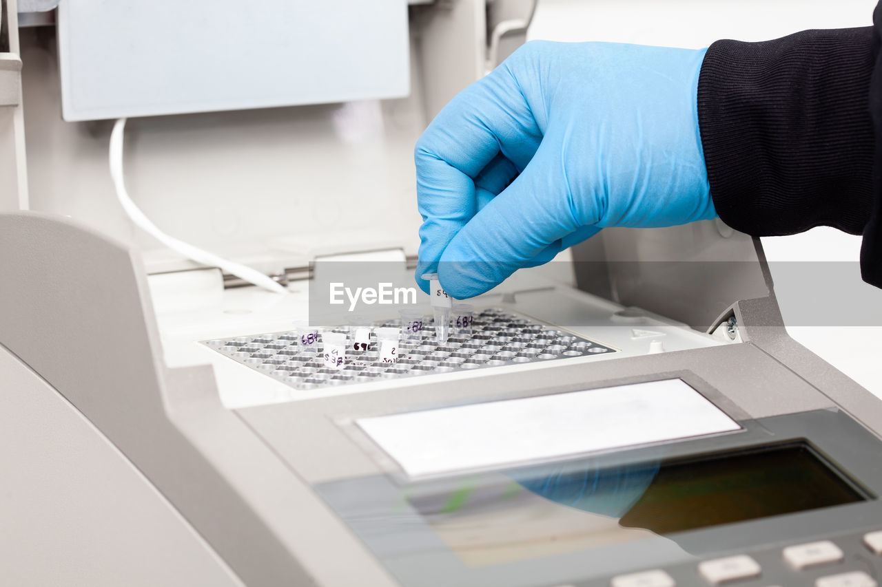 Scientist working at the laboratory with a thermal cycler. polymerase chain reaction technique. 