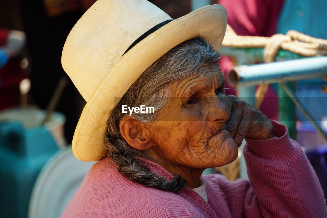 REAR VIEW OF WOMAN WITH HAT