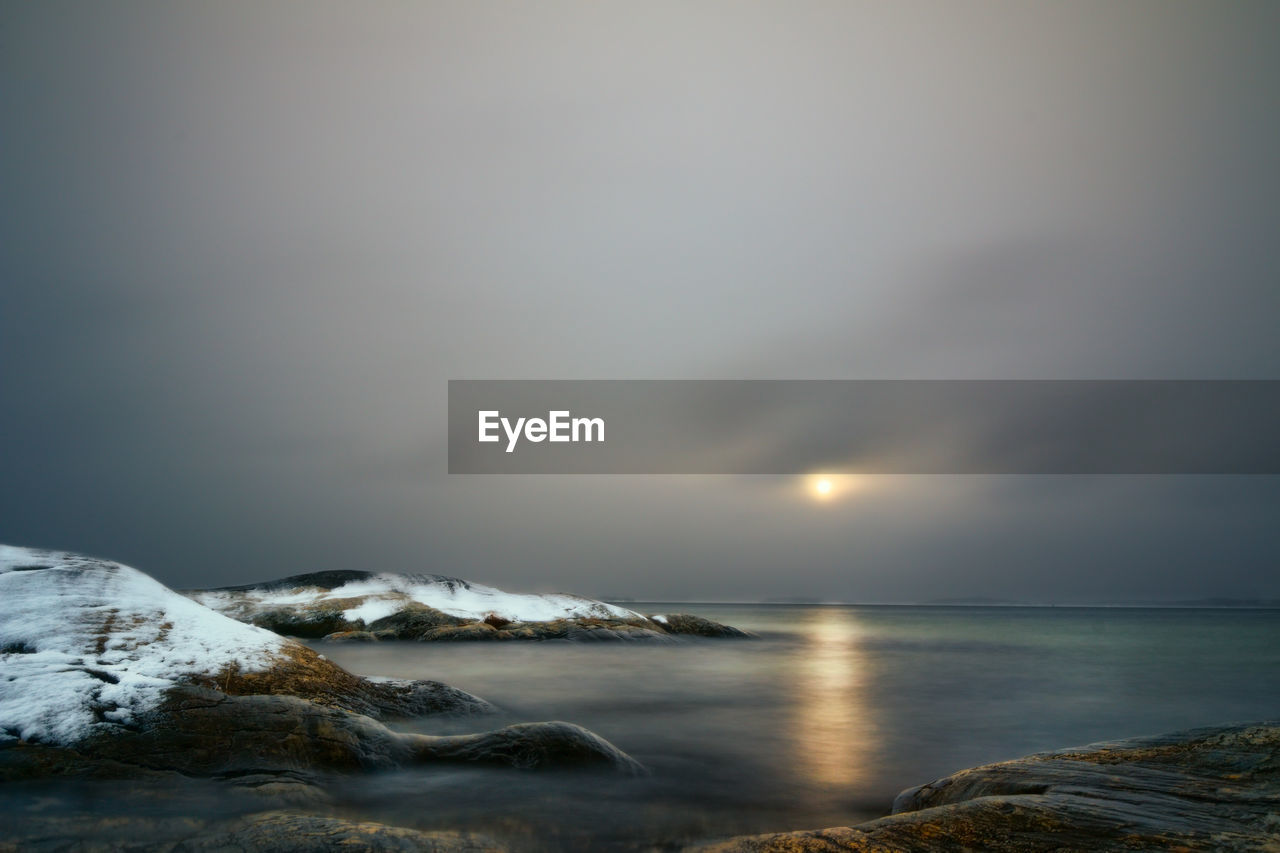 SCENIC VIEW OF SEA AND SNOWCAPPED MOUNTAINS