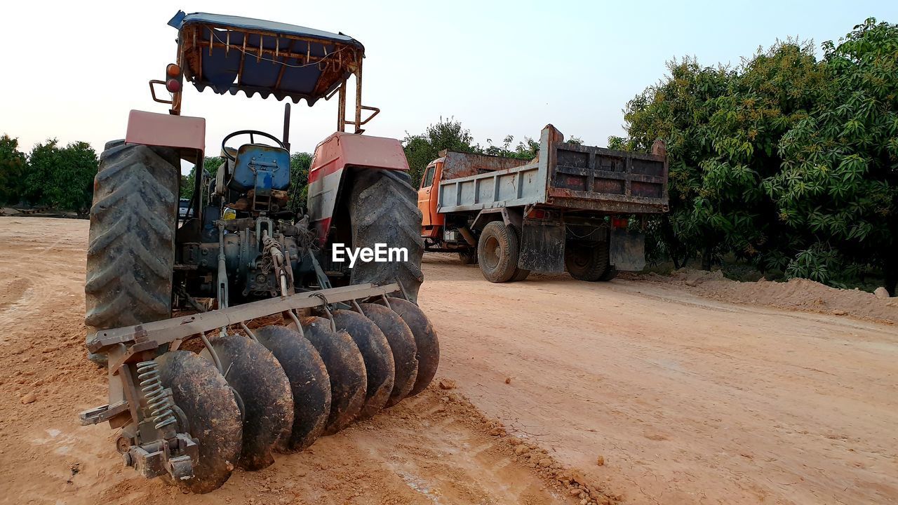 Tractor on field against clear sky