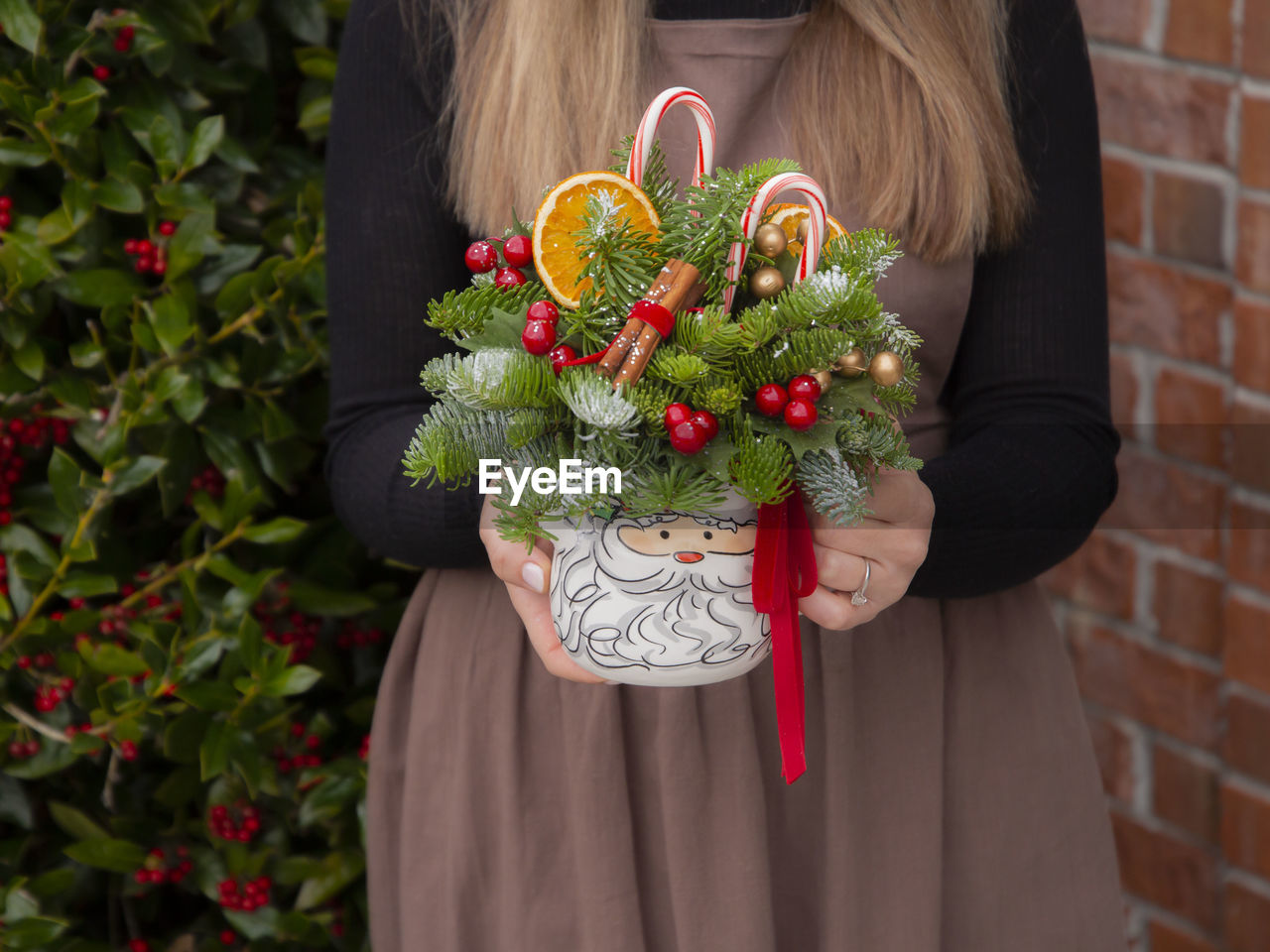 Midsection of woman holding christmas decoration