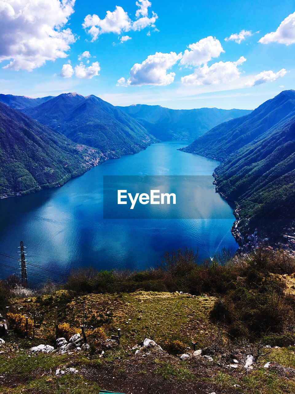 Scenic view of lake by mountains against sky