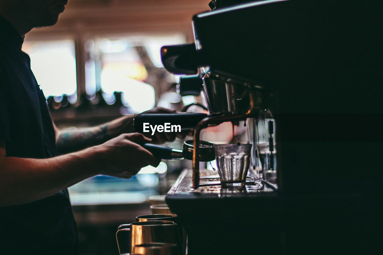 Close-up of hands preparing coffee