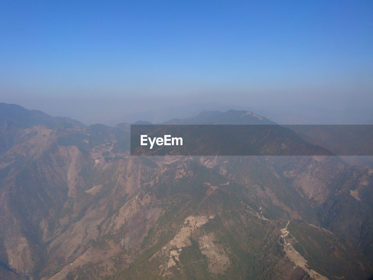 Aerial view of mountain range against clear sky