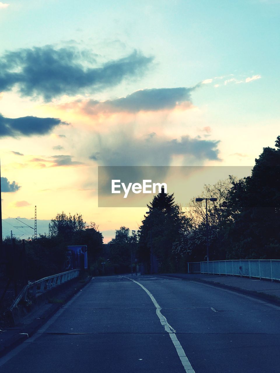 VIEW OF ROAD AGAINST SKY AT SUNSET