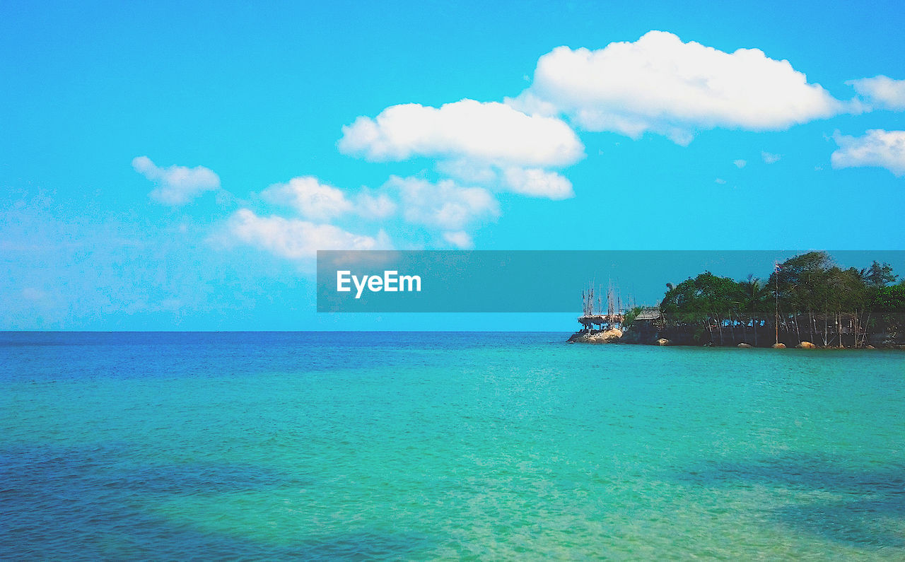 Scenic view of sea against blue sky