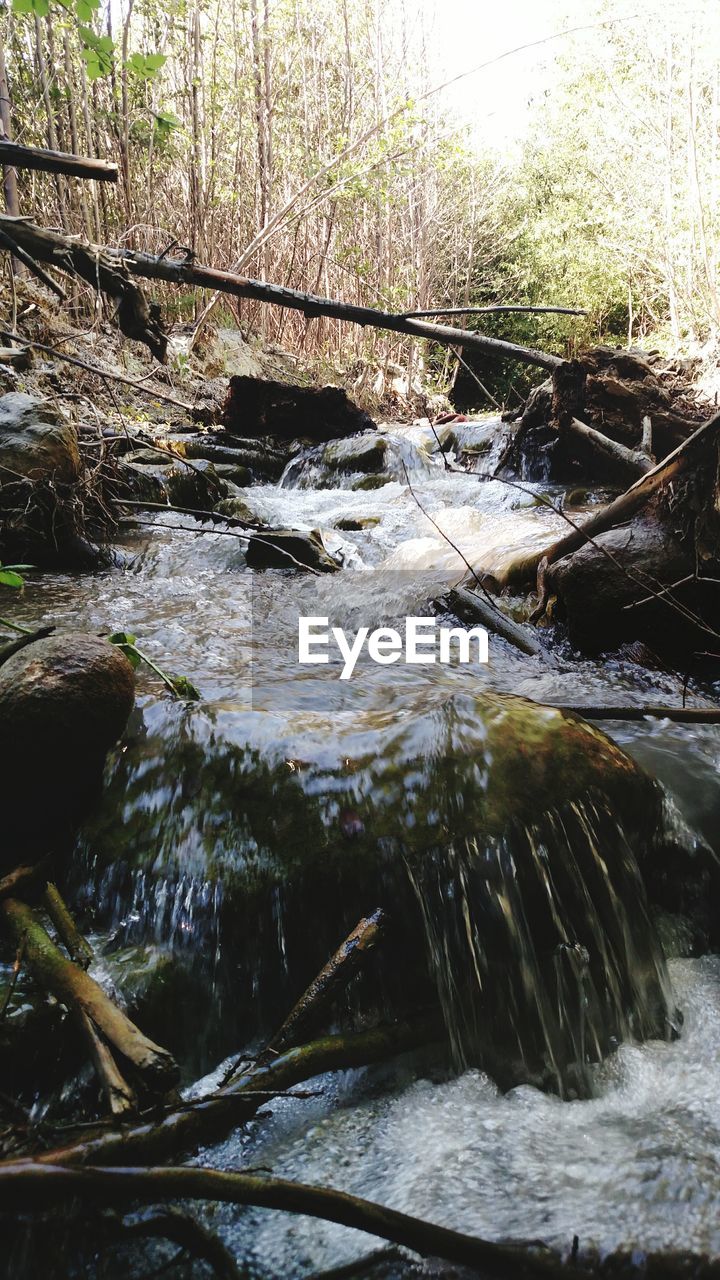 SCENIC VIEW OF RIVER FLOWING THROUGH ROCKS