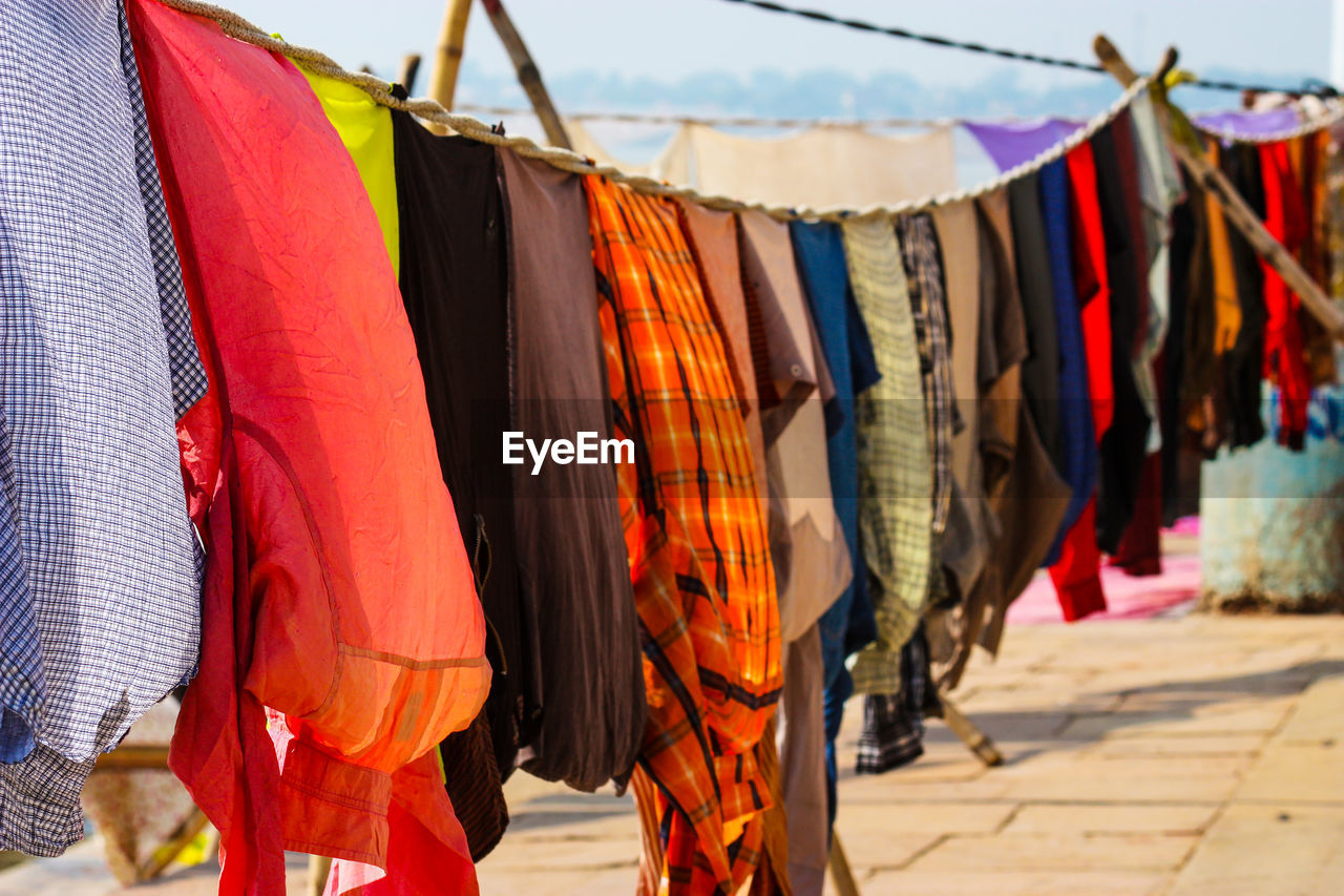 CLOTHES DRYING ON CLOTHESLINE AGAINST WALL