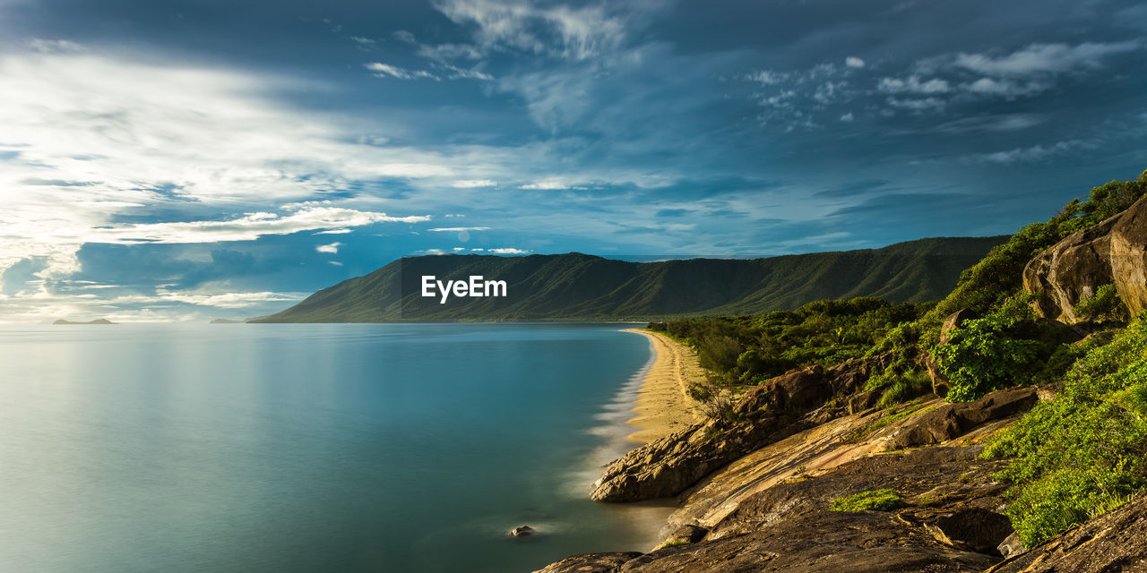 Scenic view of sea and mountains against sky