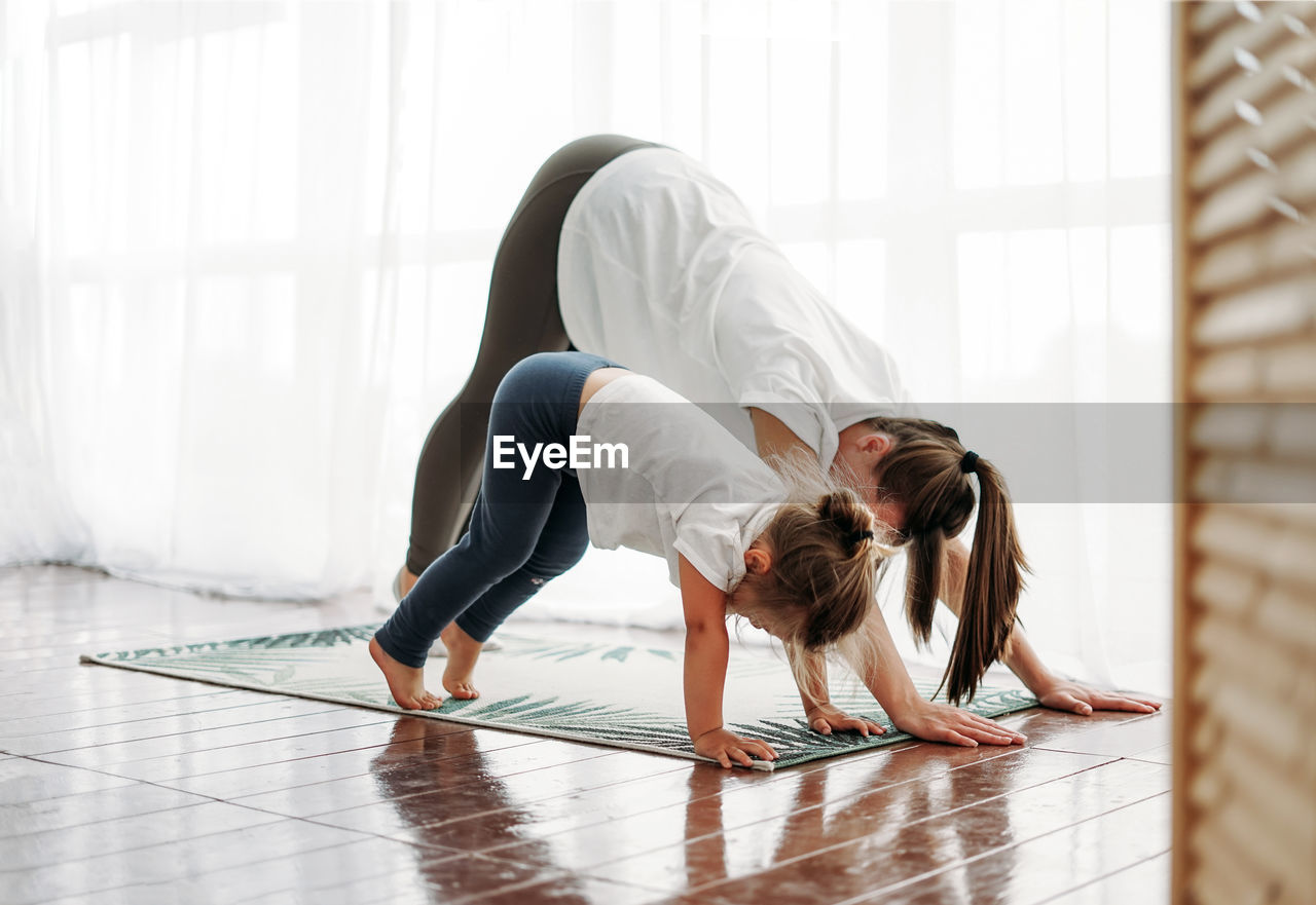 Mother and daughter exercising at home