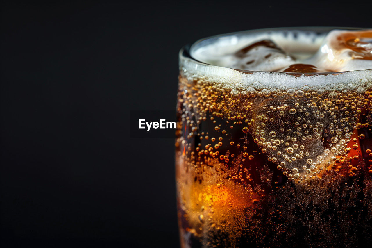 close-up of drink in glass on black background