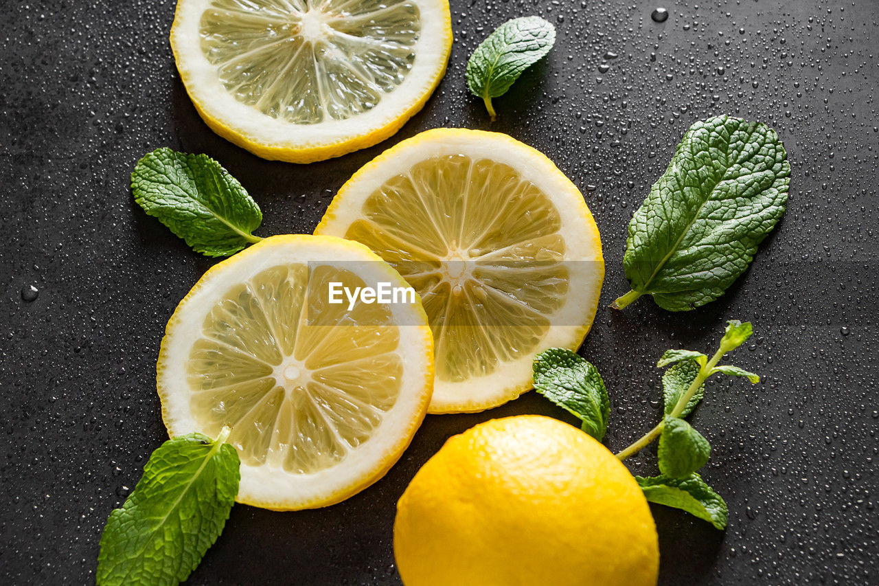food and drink, food, citrus fruit, fruit, healthy eating, freshness, lime, lemon, citrus, plant, wellbeing, leaf, slice, herb, plant part, produce, indoors, mint leaf - culinary, no people, studio shot, still life, cross section, ingredient, directly above, refreshment, nature, high angle view, drink, yellow, close-up, green, citron