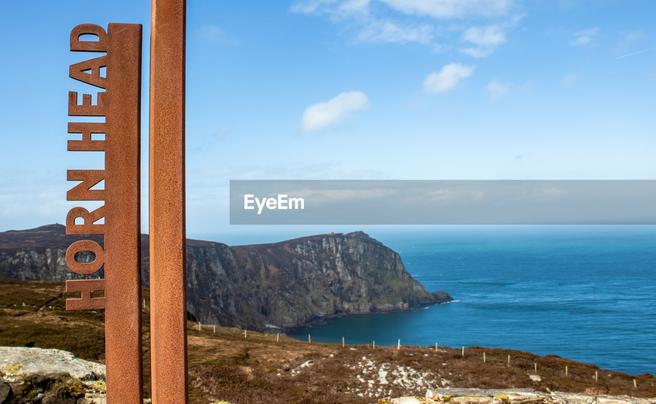 Scenic view of sea and mountains against sky