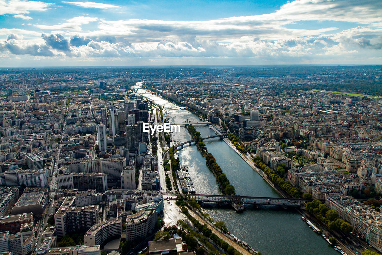 Aerial view of seine river amidst cityscape against sky