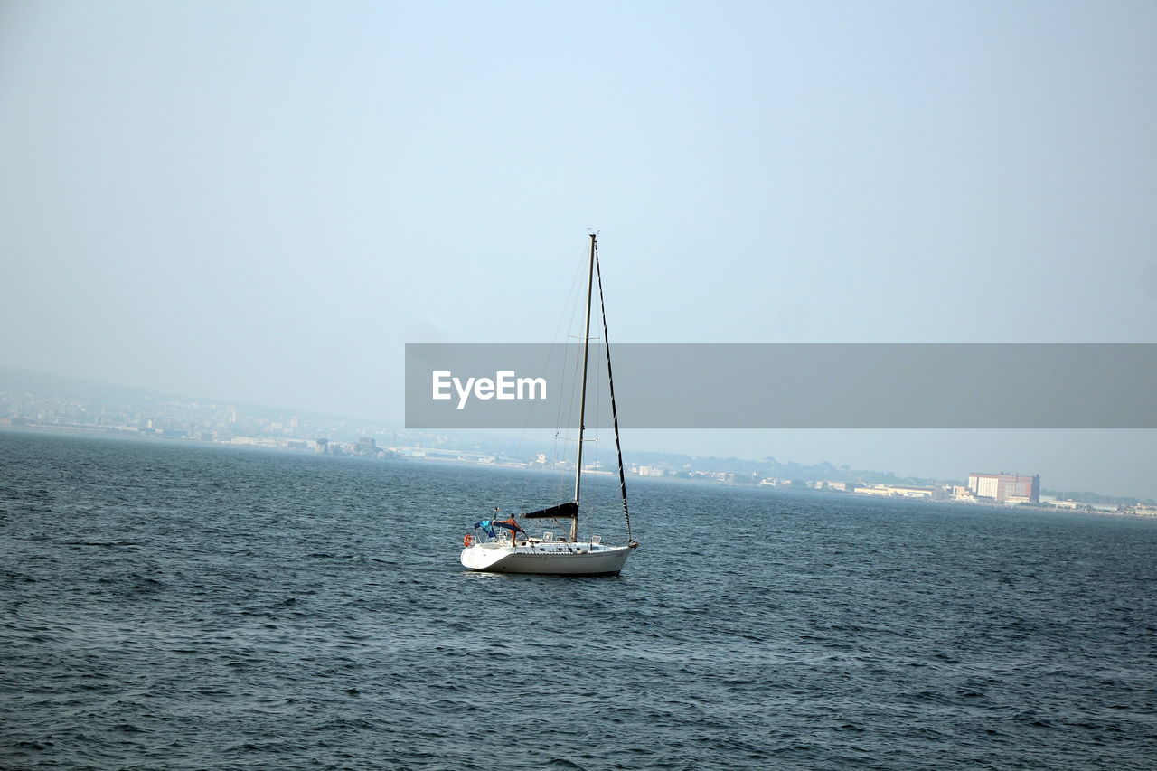 SAILBOATS SAILING IN SEA AGAINST SKY