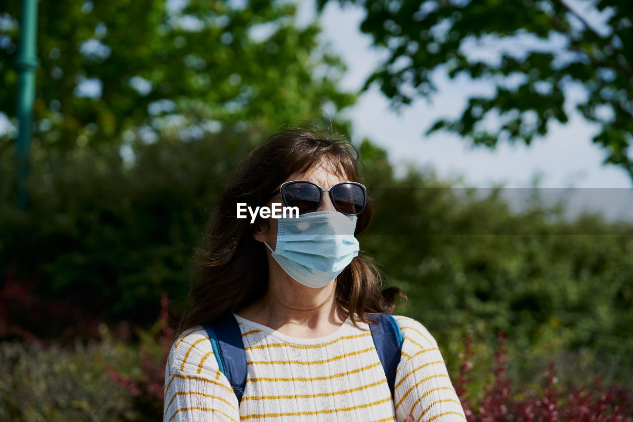 Woman in mask in park