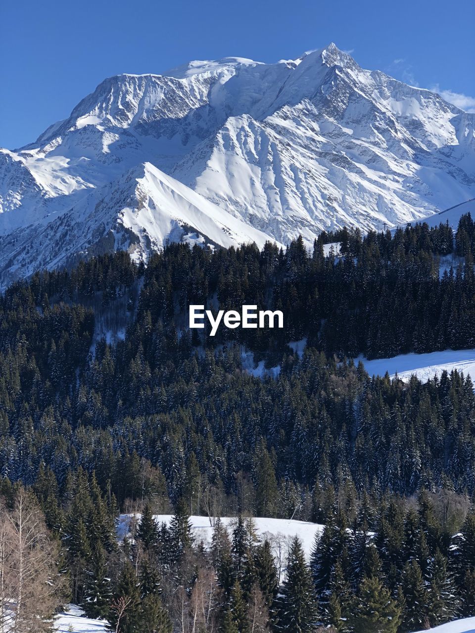 SNOW COVERED LANDSCAPE AGAINST MOUNTAIN RANGE