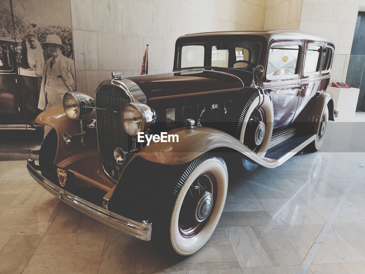 VINTAGE CAR ON FLOOR IN GARAGE