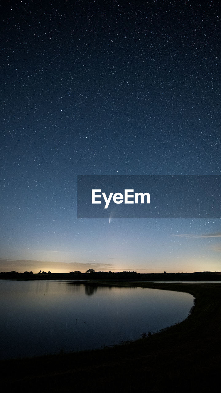 Scenic view of lake against sky at night neowise comet