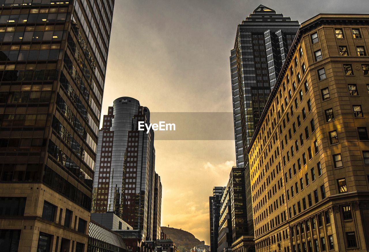 Low angle view of skyscrapers at sunset