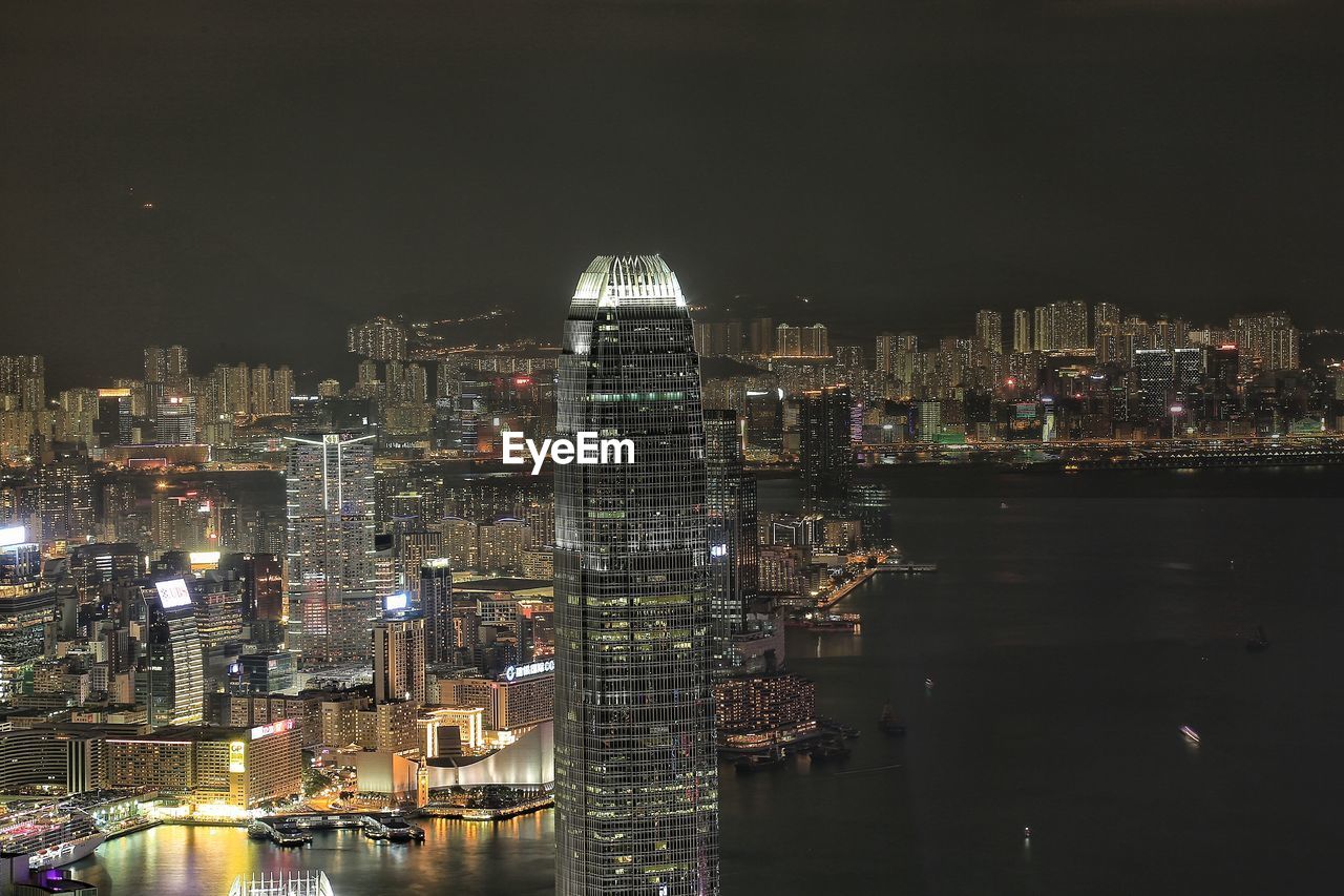 Illuminated cityscape against sky at night