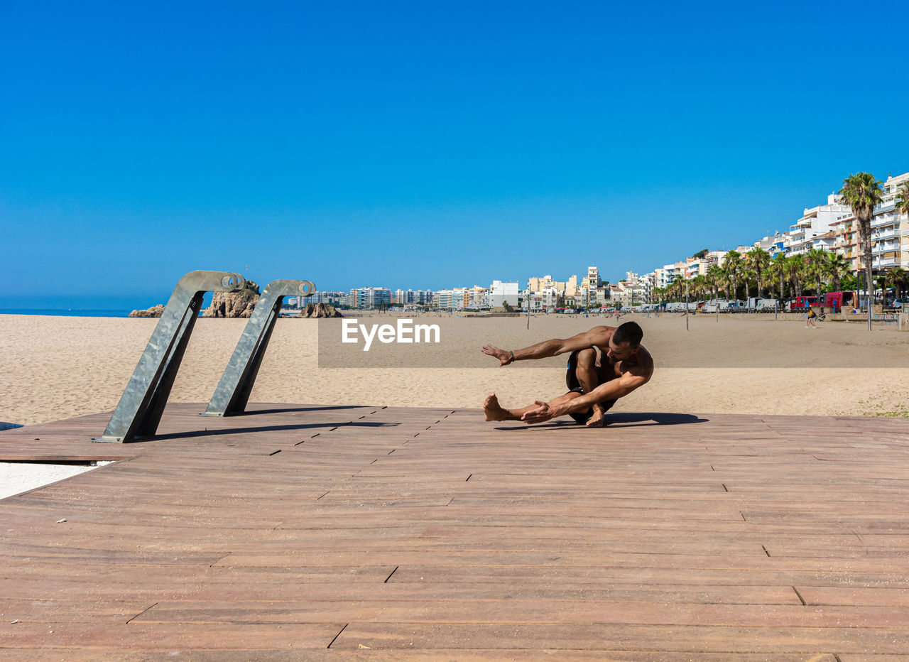 Sportsman practicing stretching and calisthenics