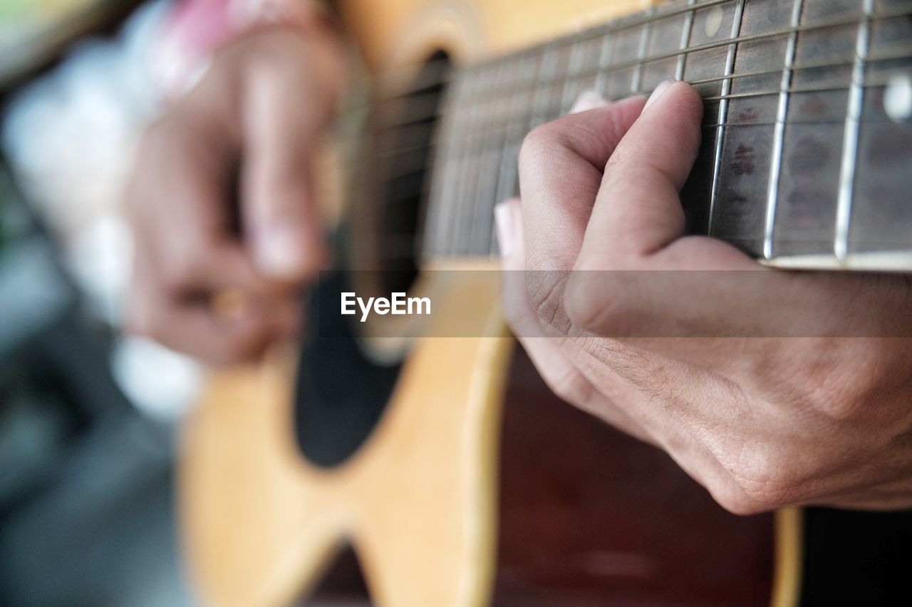 Close-up of hand playing the guitar