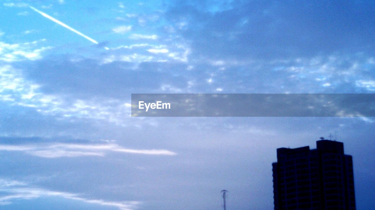 LOW ANGLE VIEW OF VAPOR TRAILS IN SKY
