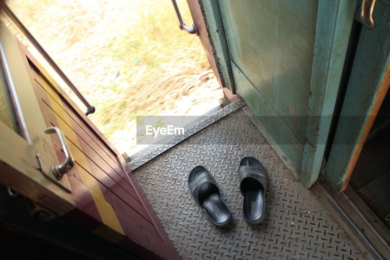 High angle view of slippers at train door