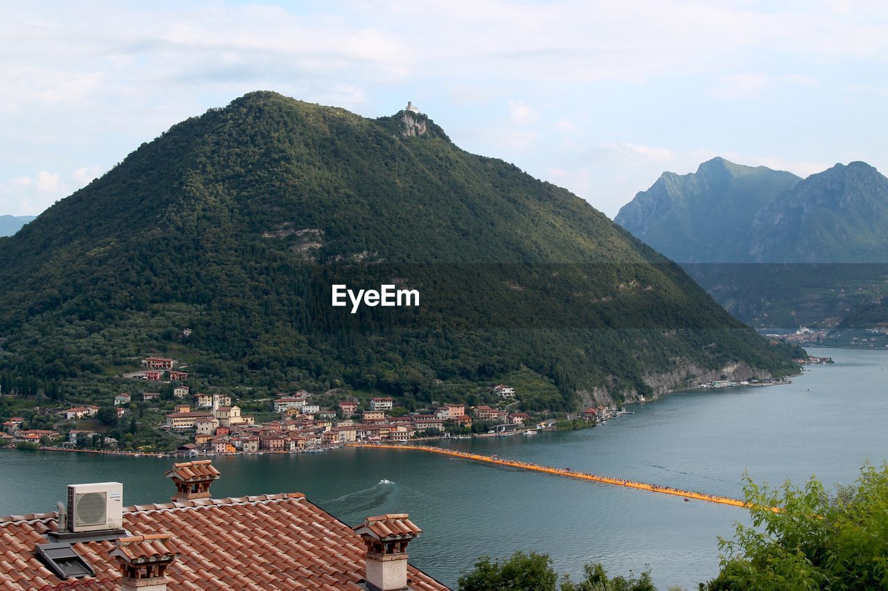 SCENIC VIEW OF MOUNTAINS AND TREES AGAINST SKY