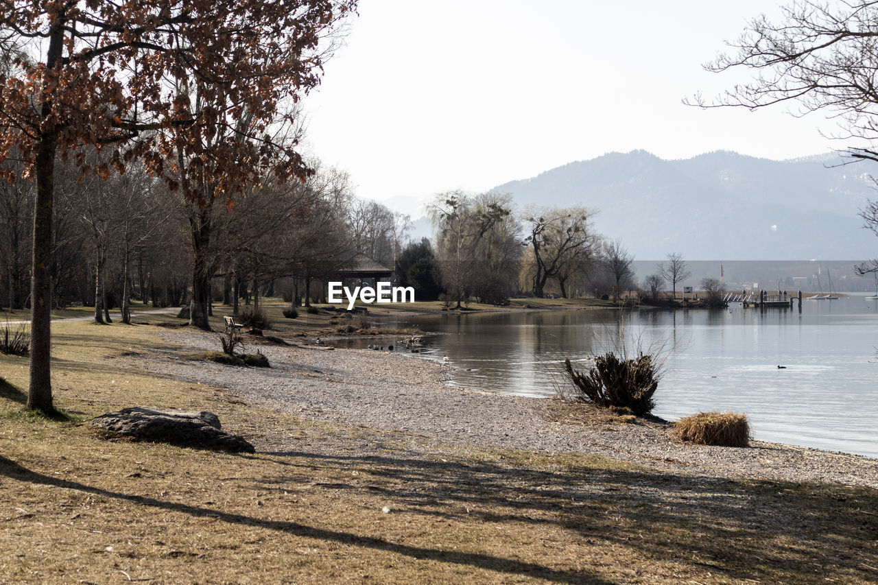 tree, water, nature, plant, river, winter, sky, scenics - nature, tranquility, beauty in nature, no people, morning, tranquil scene, day, environment, body of water, reflection, outdoors, shore, landscape, land, mountain, sunlight, non-urban scene, travel destinations