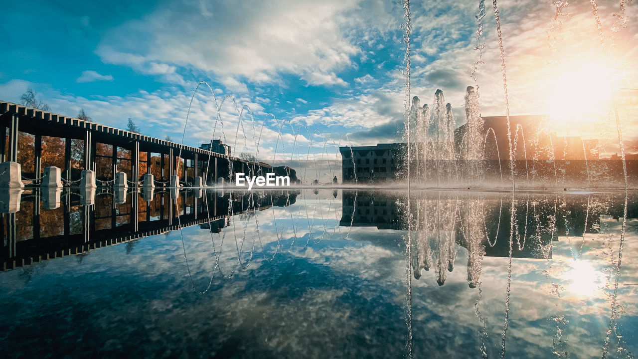 View of swimming pool in lake against cloudy sky