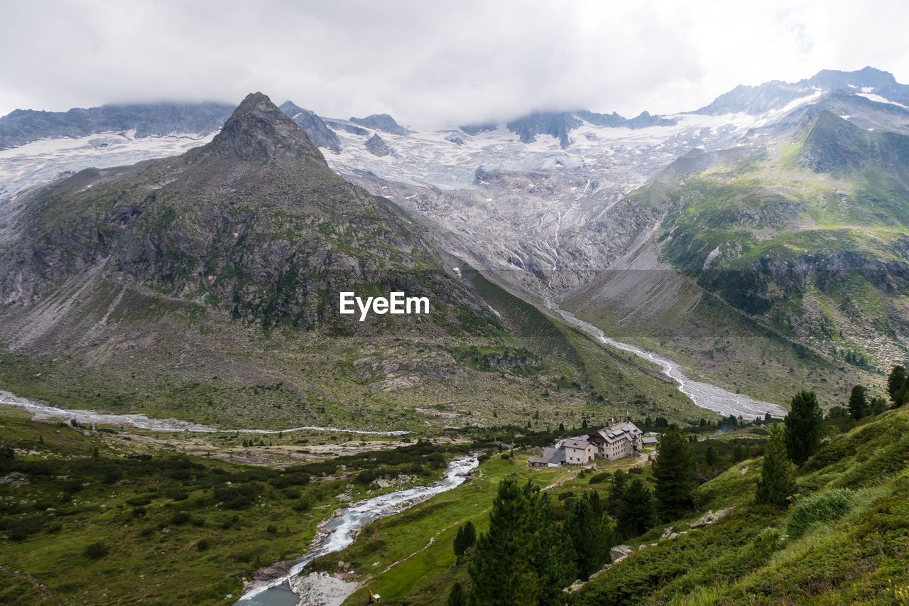 View on alpine mountain range with a glacier in background including the mountain hut berliner hütte