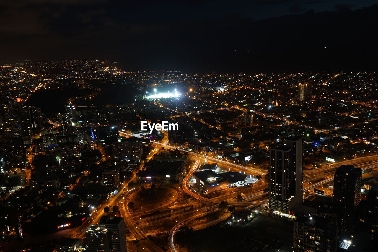 AERIAL VIEW OF ILLUMINATED CITY AT NIGHT