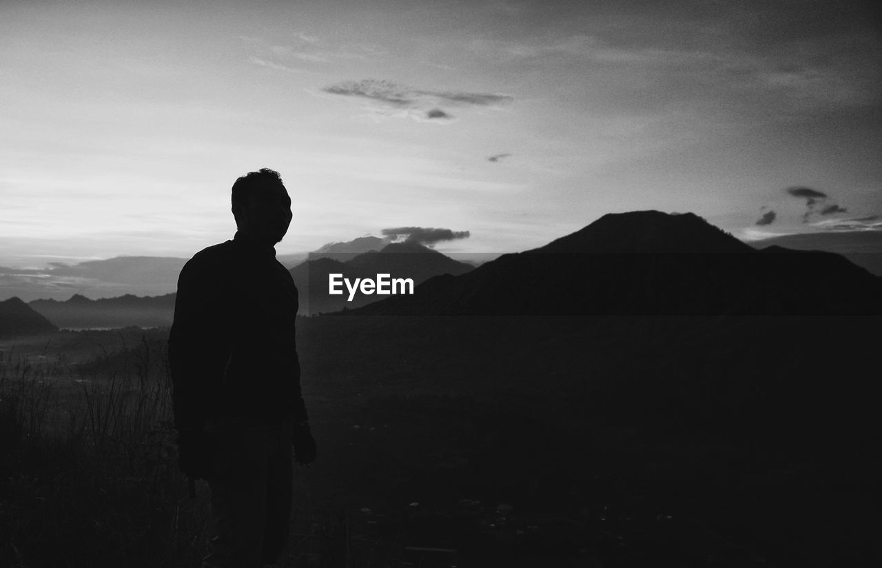 Silhouette of man standing on mountain