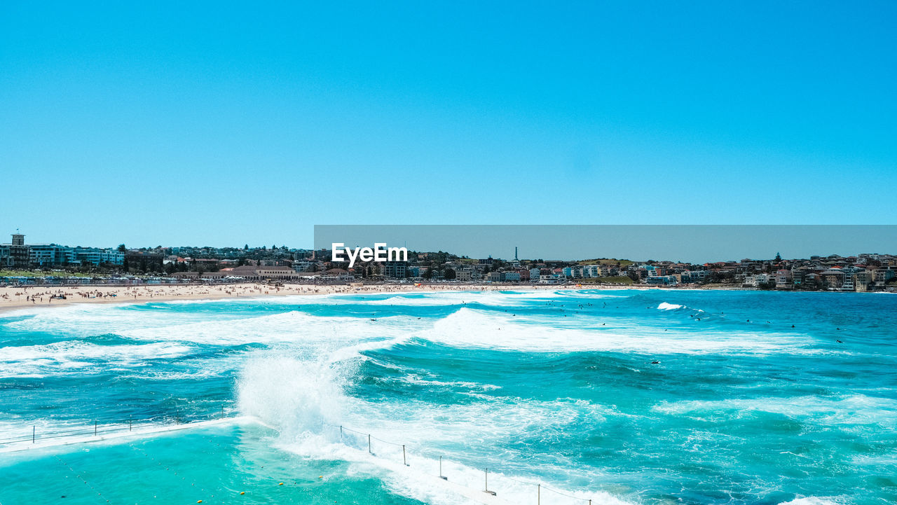 Scenic view of sea against clear blue sky