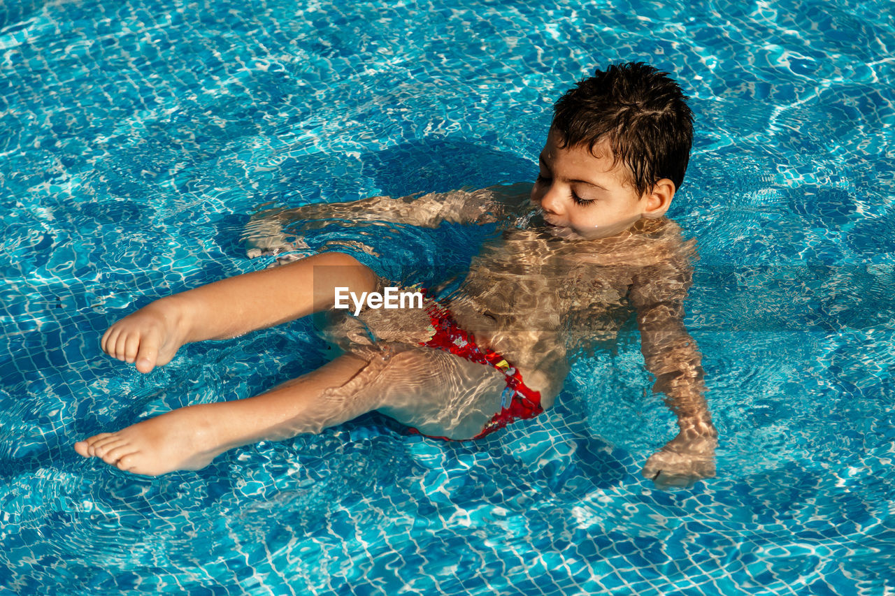 Boy swimming in pool