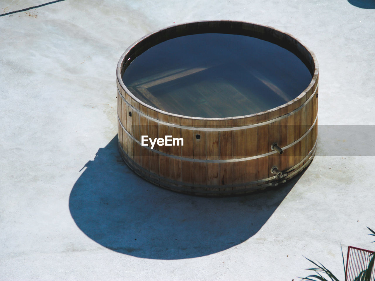 High angle view of water in wooden container during sunny day