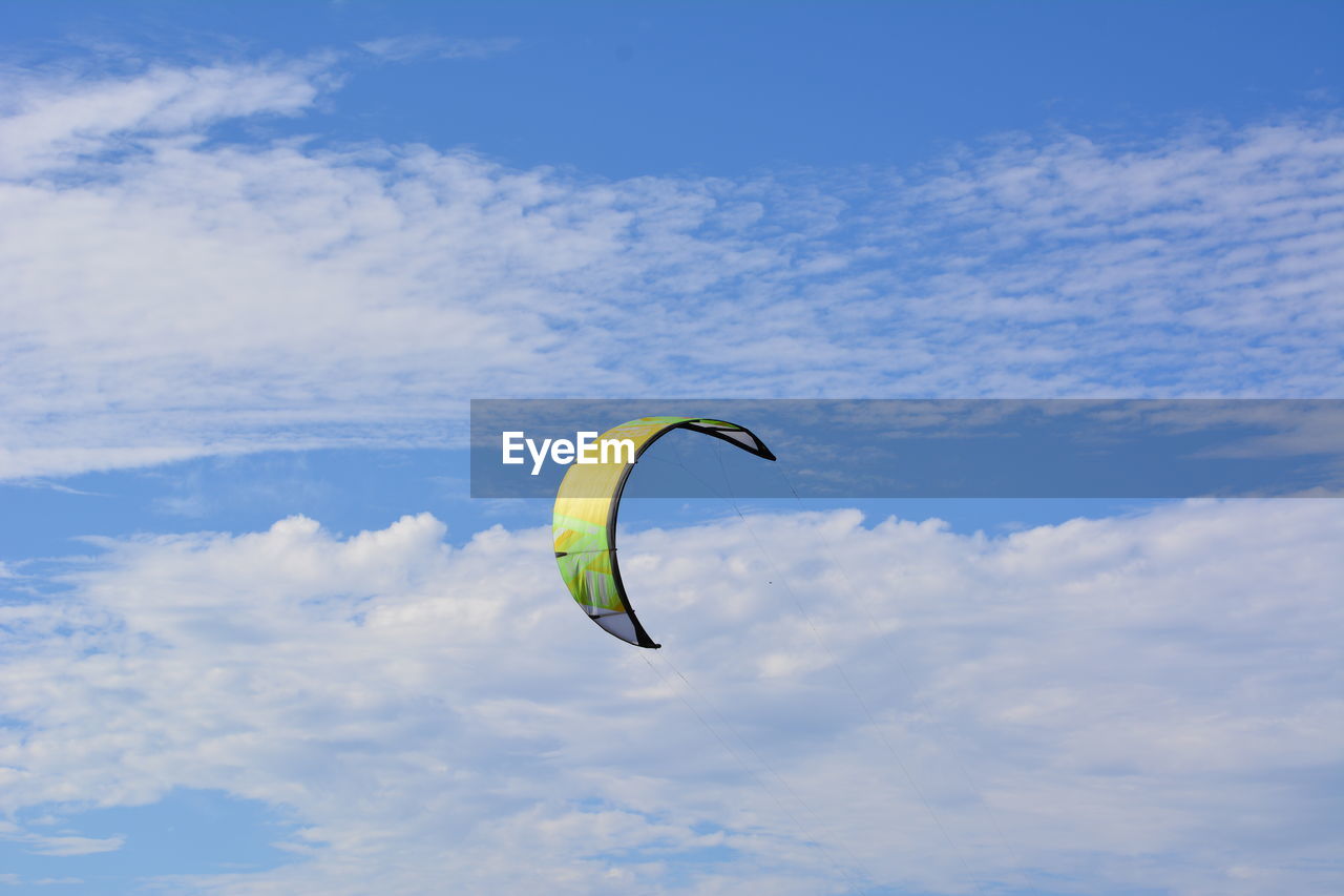 Low angle view of kite flying against sky