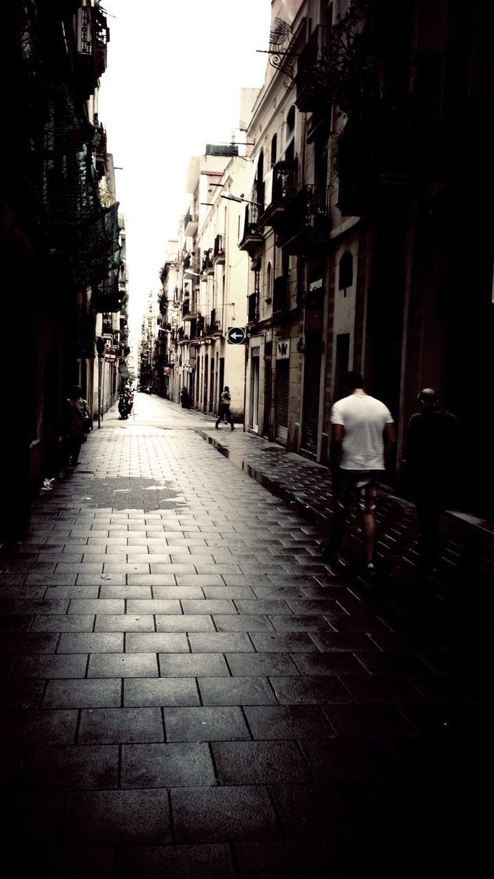 NARROW WALKWAY ALONG BUILDINGS