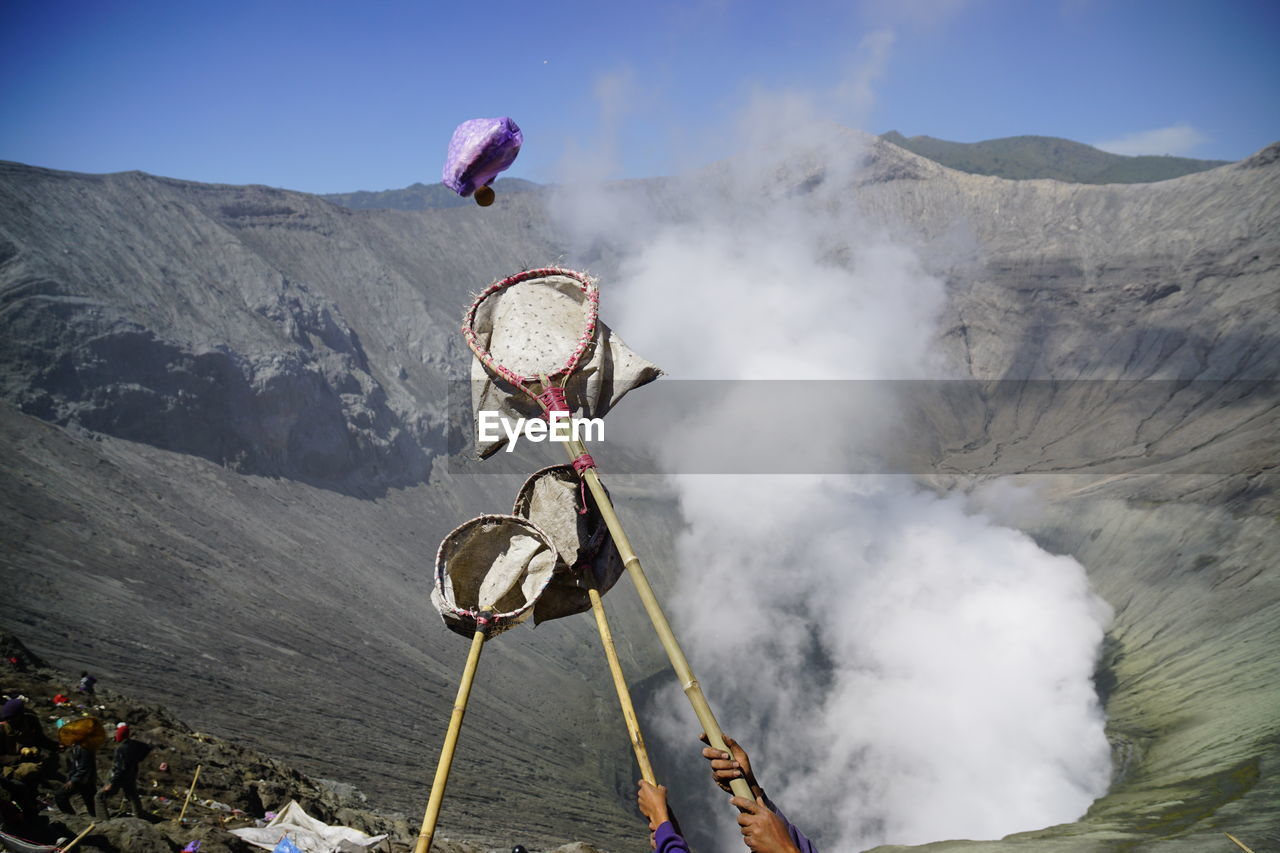 Offering falling in bird catching net during kasada festival at mt bromo