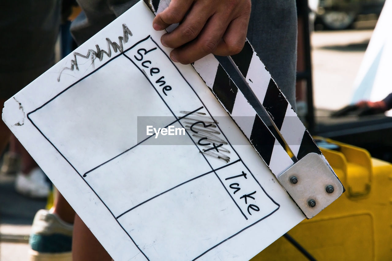 Close up image of film production crew holding film slate on set