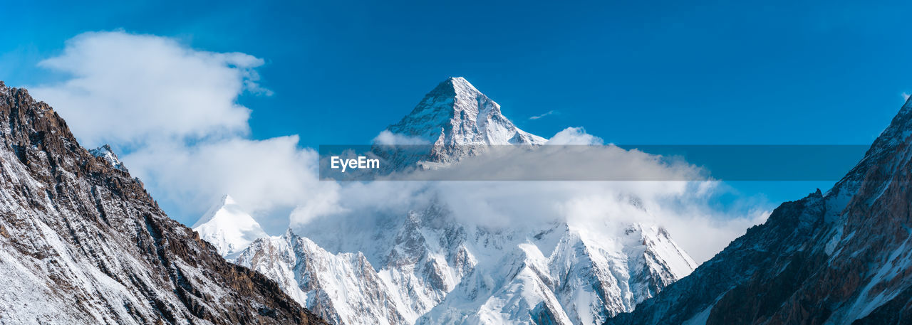 Panoramic view of snowcapped mountains against sky